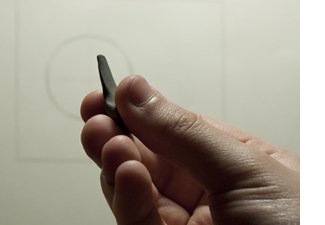 Shaping the tip of the kneaded eraser.