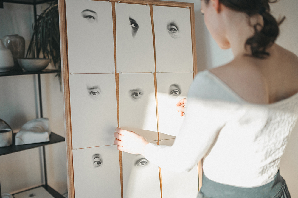 Marina Fridman arranging some realistic eye drawings