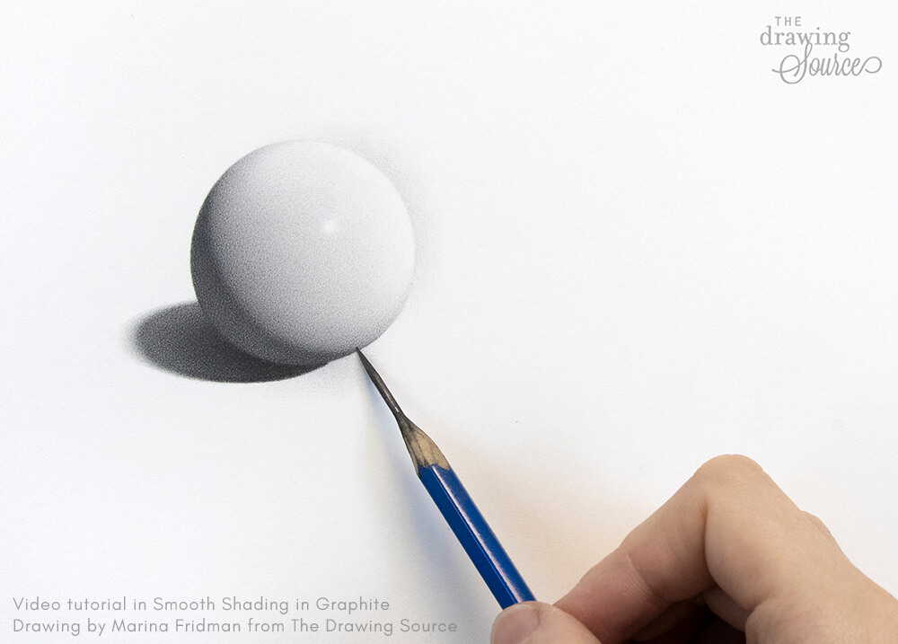 A realistic sphere drawn in graphite, showing smooth shading and all the elements of light and shadow, with the artist's hand and pencil in frame.