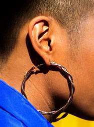 The free reference photo of the ear with a large hoop earring, drawn by Marina Fridman using charcoal and white pencils in her How to Draw an Ear on Toned Paper tutorial at The Drawing Source.